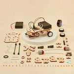 DIY car robotics kit with wooden components and electronic parts on a beige background