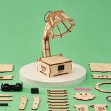 Wooden DIY lamp kit on a green background with components scattered around